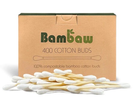 Bambaw organic cotton bamboo cotton swabs laying in a pile in front of an unbleached cardboard packaging