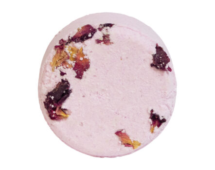 pink rose scented bath bomb with real rose petals against white background