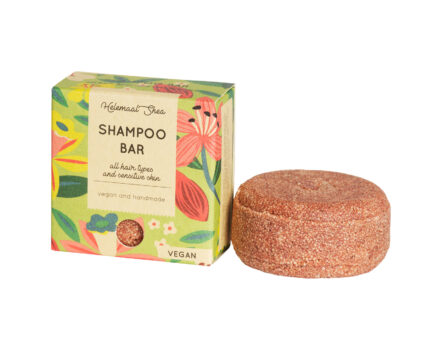 Tropisch gekleurde doos met bruine shampoobar ernaast.