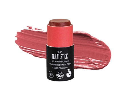 Afbeelding van een roodbruine multi-stick voor lippen en wangen, met ernaast een swatch van de romige textuur. De kleur is een mix van roze en warm bruin, vergelijkbaar met een stoffige zonsondergang of een blozende wijn.