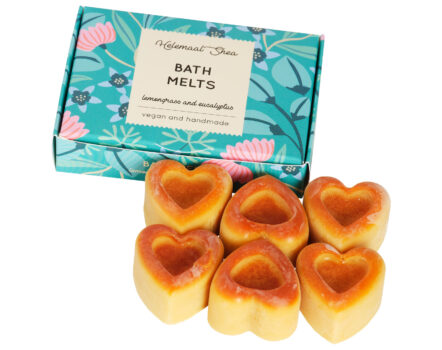 blue paper box next to orange heart bath melts in scent lemongrass and eucalyptus