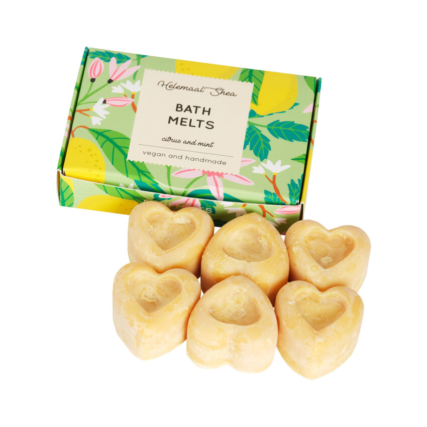 Green paper box nexy to yellow heart shaped bath melts in the cent citrus mint