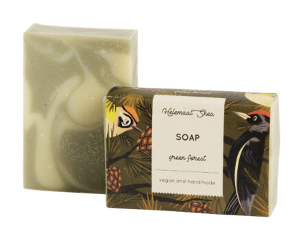 green colored Green Forest soap next to a darkly colored packaging made from recycle materials